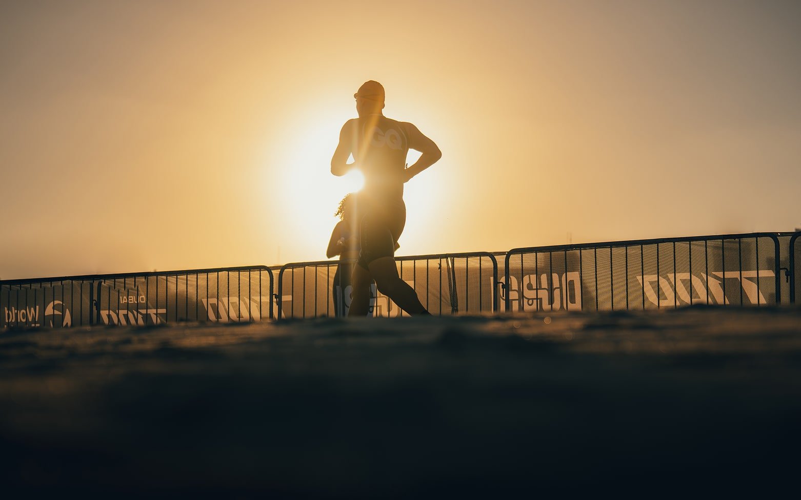 Athlete running to transition in the Dubai T100